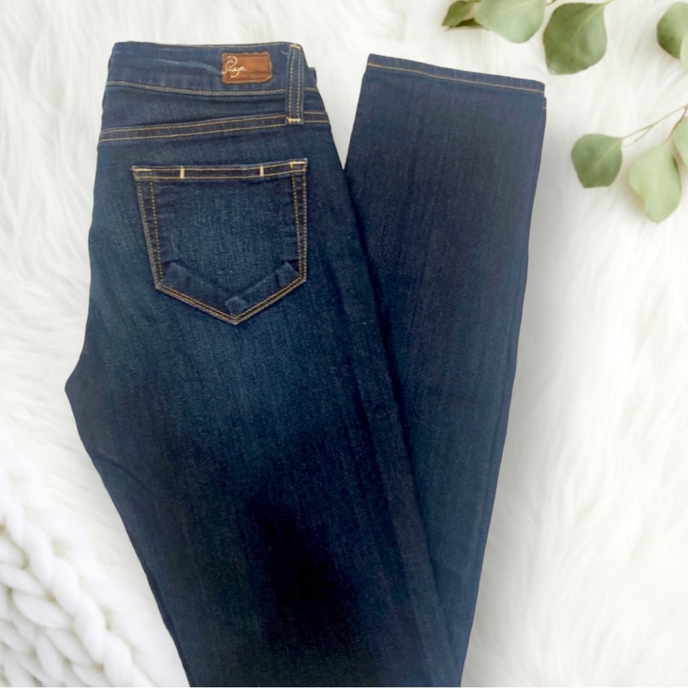 Paige Premium Denim. “Peg Skinny” jeans in dark wash.